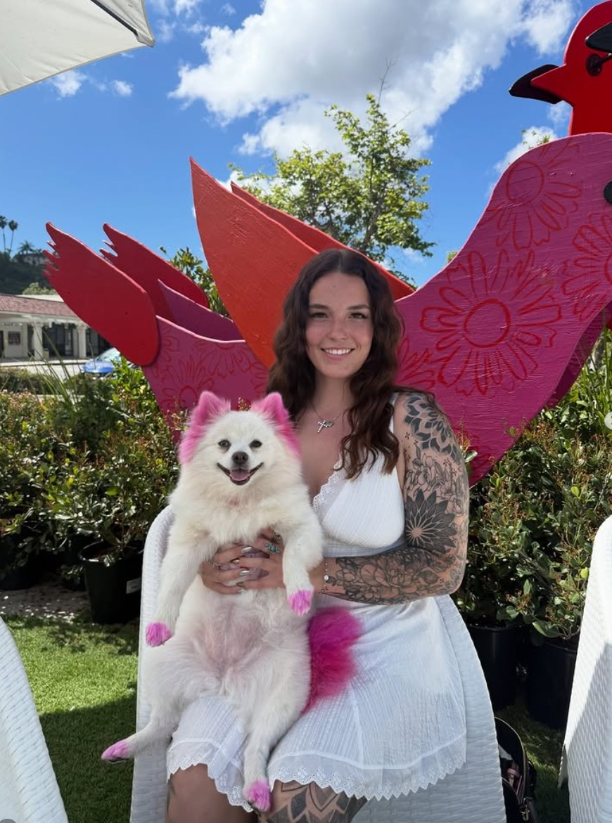Mobile dog groomer interacting happily with a dog in Orange County